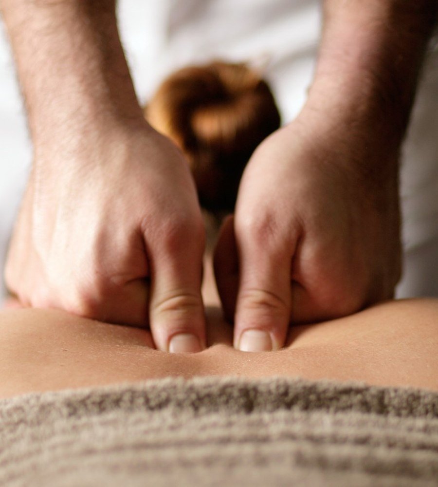 Hands providing a relaxing back massage